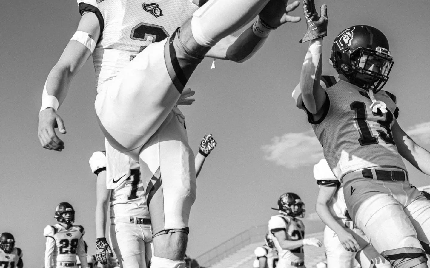 American football players warming up on the field before a game